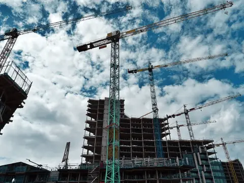 High-rise under construction with tower cranes