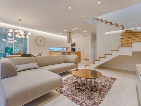 Open-plan living room with a floating staircase