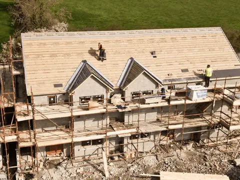 Roofing crew working on a new house